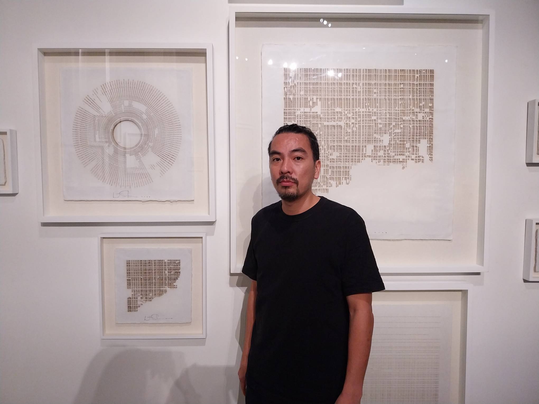 Artist Wataru Sakuma in front of one of his works for "Crisis in Meaning."