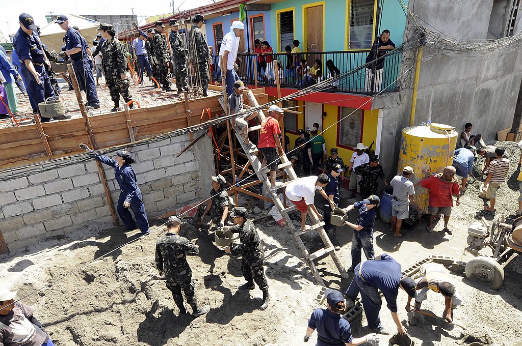 Soldiers helping build a housing project. Photo by Peter D. Lawlor. Source: Wikimedia Commons.