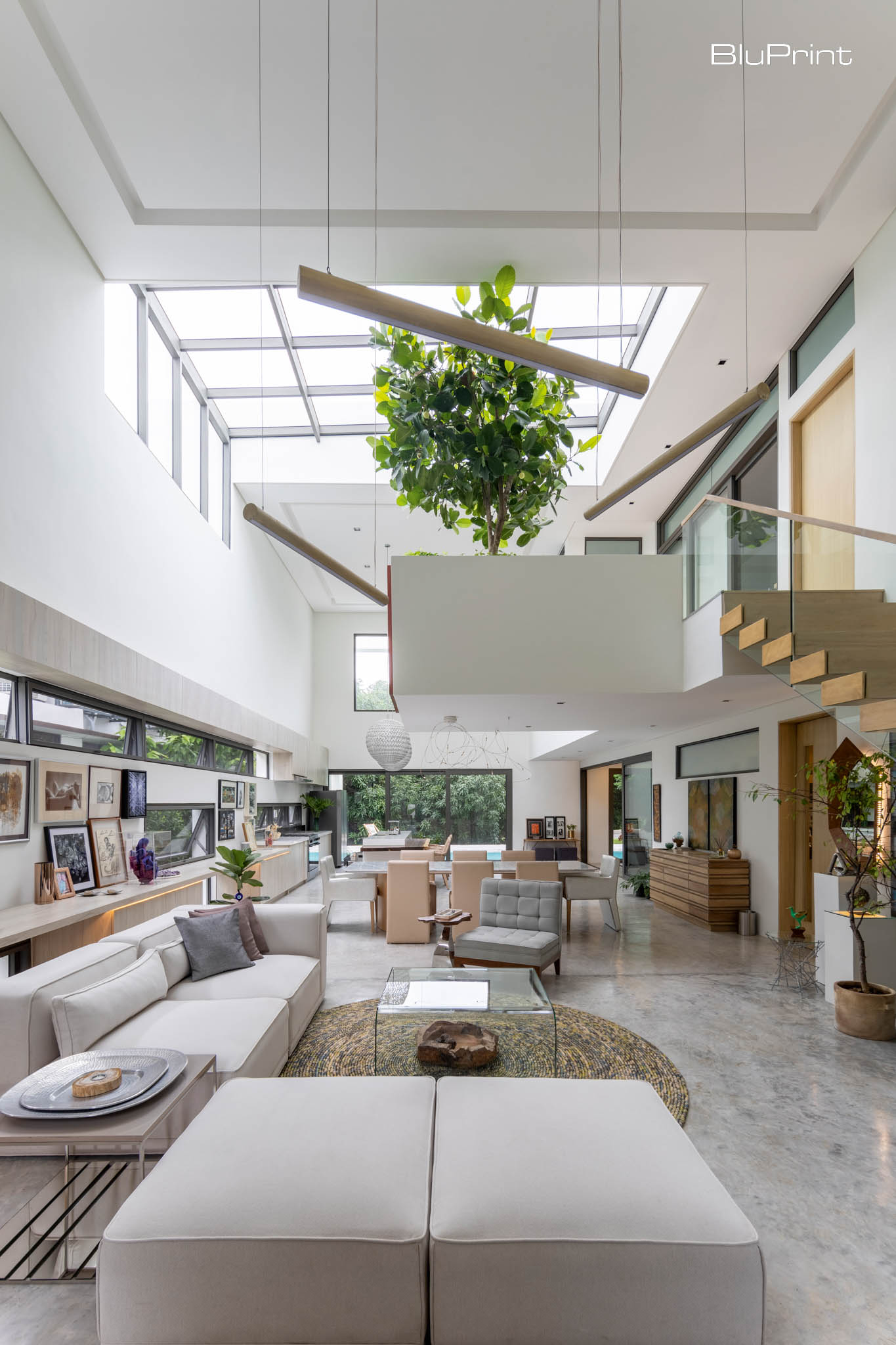 Tampipi House: Designing Outside the Box by Carlo Calma. The glass skylight allows natural light to pour in, creating bright and airy interiors. Meanwhile, furniture in neutral tones lends the spaces a refined look.