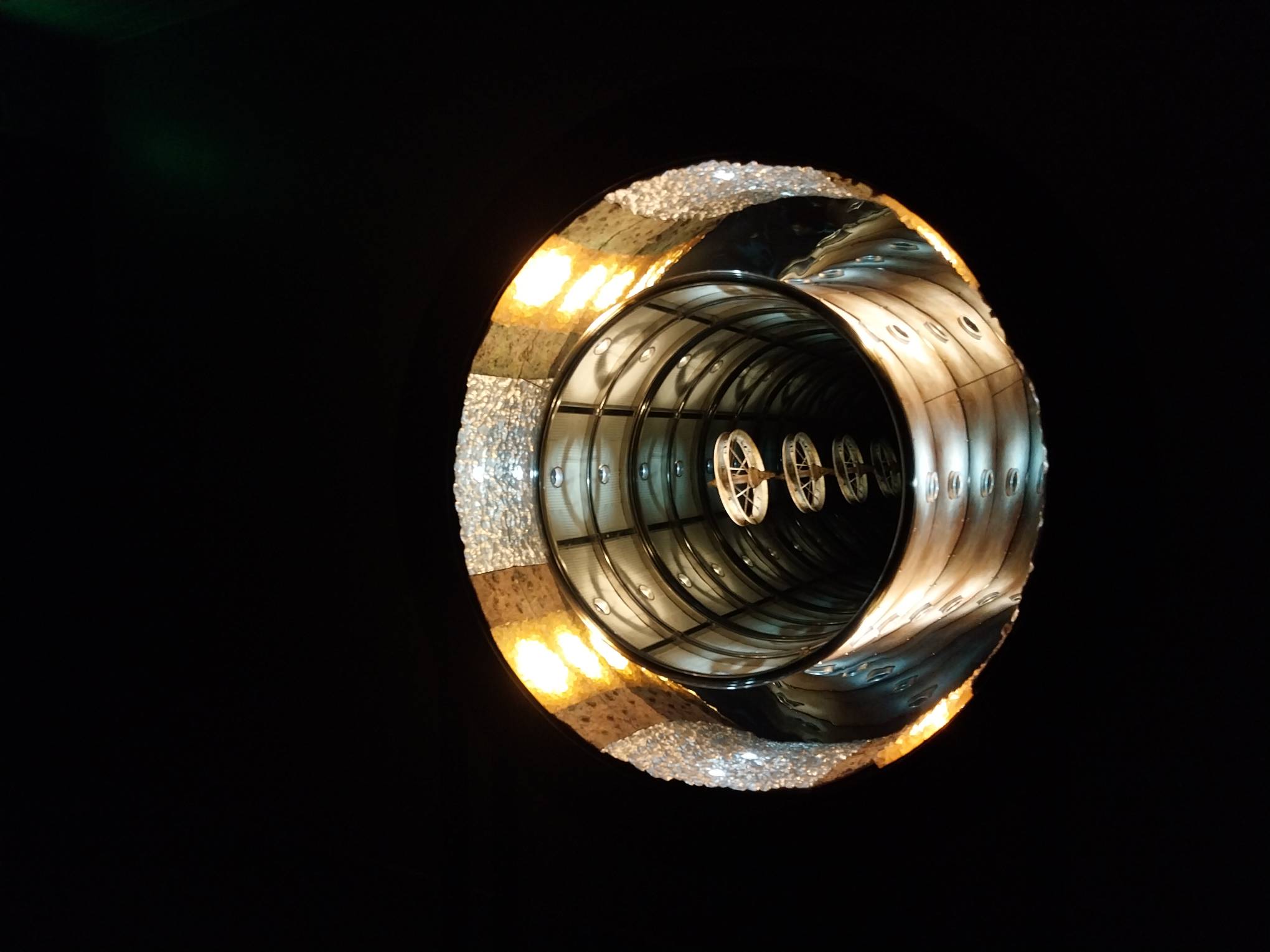 A wheel spoke elevated in a circular mirror field.