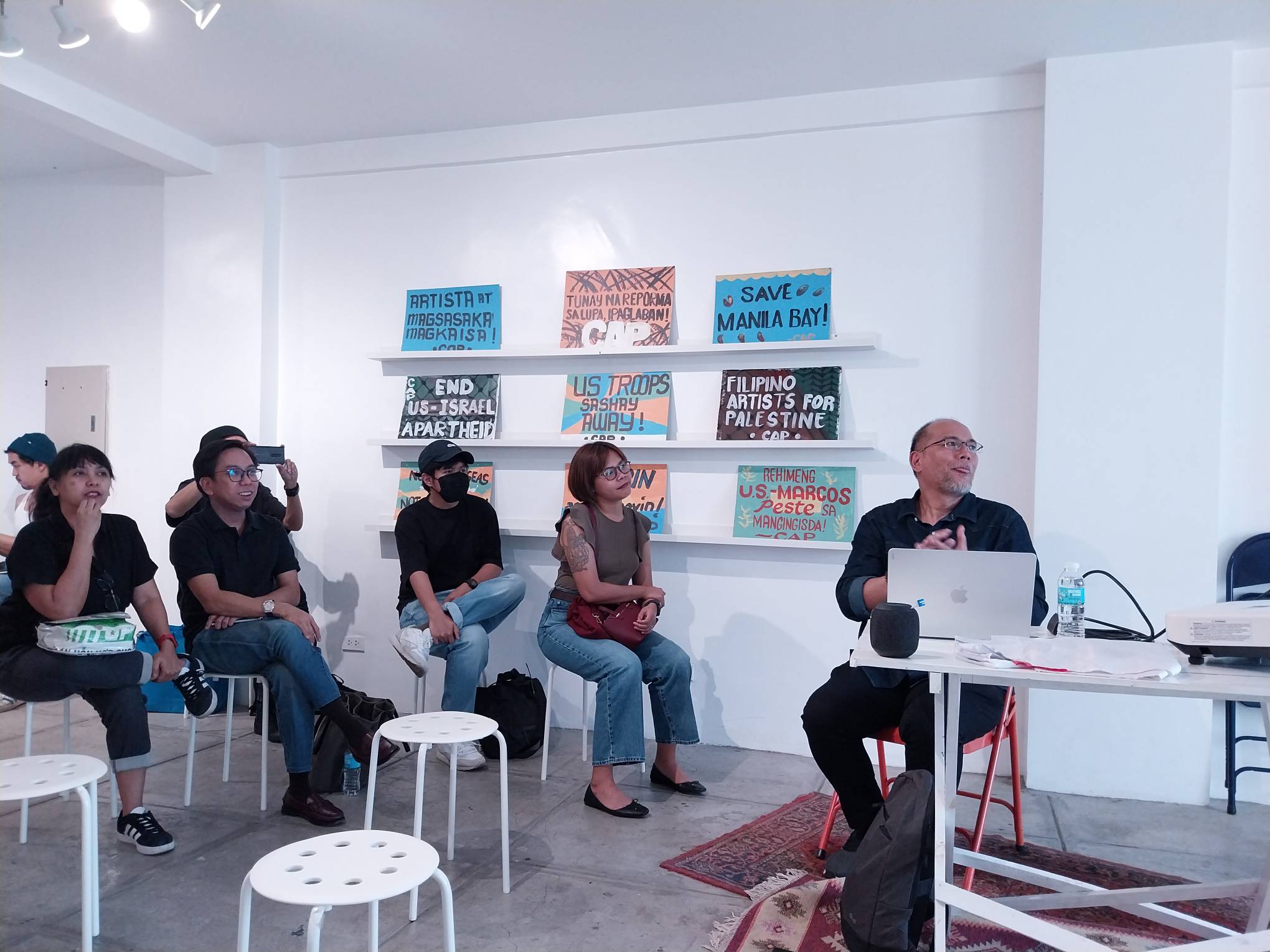 Justin Nicolas in the midst of the discussion with visitors and members of the Concerned Artists of the Philippines.
