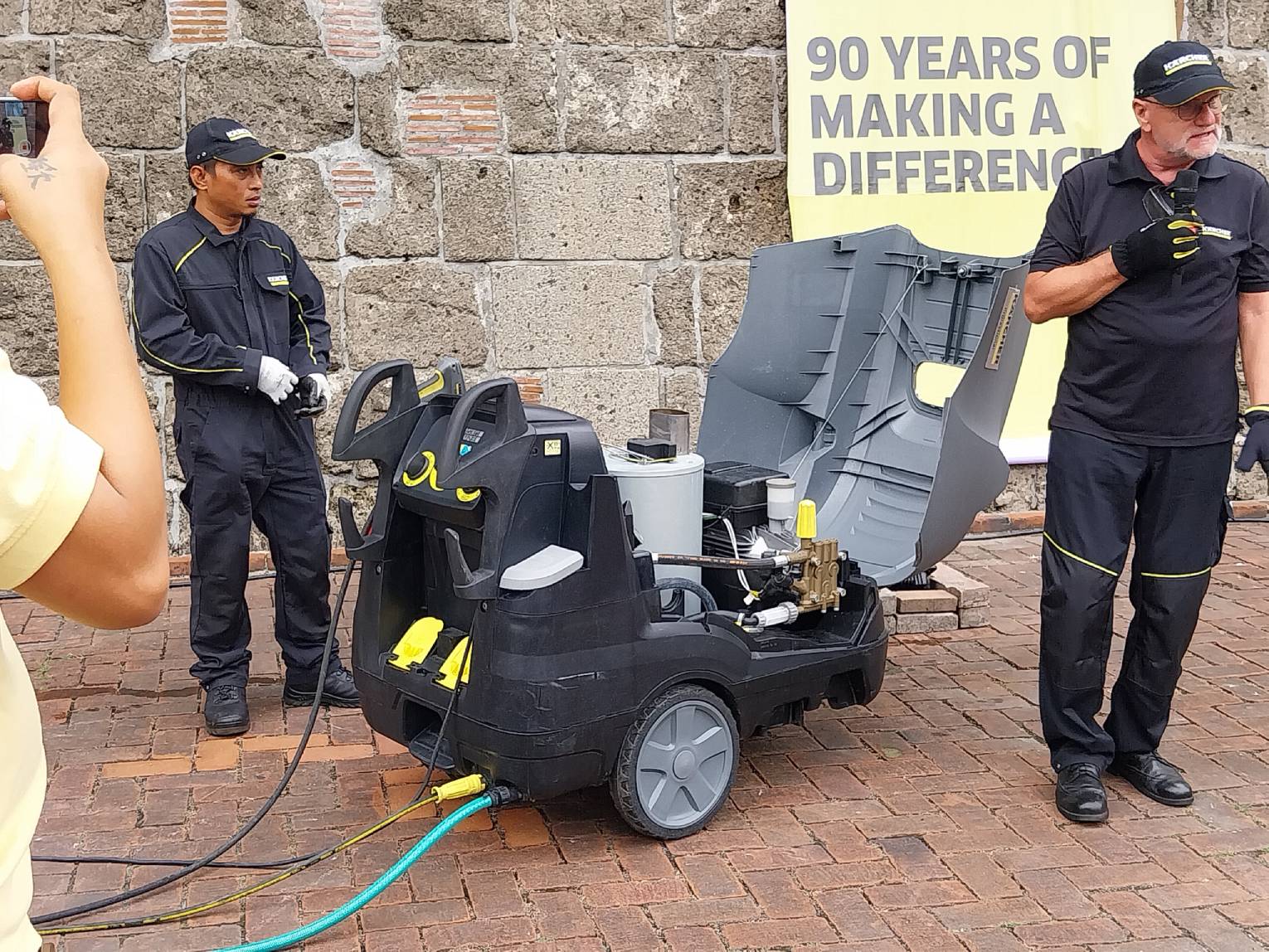 The Kärcher crew discussing the machinery of their work.