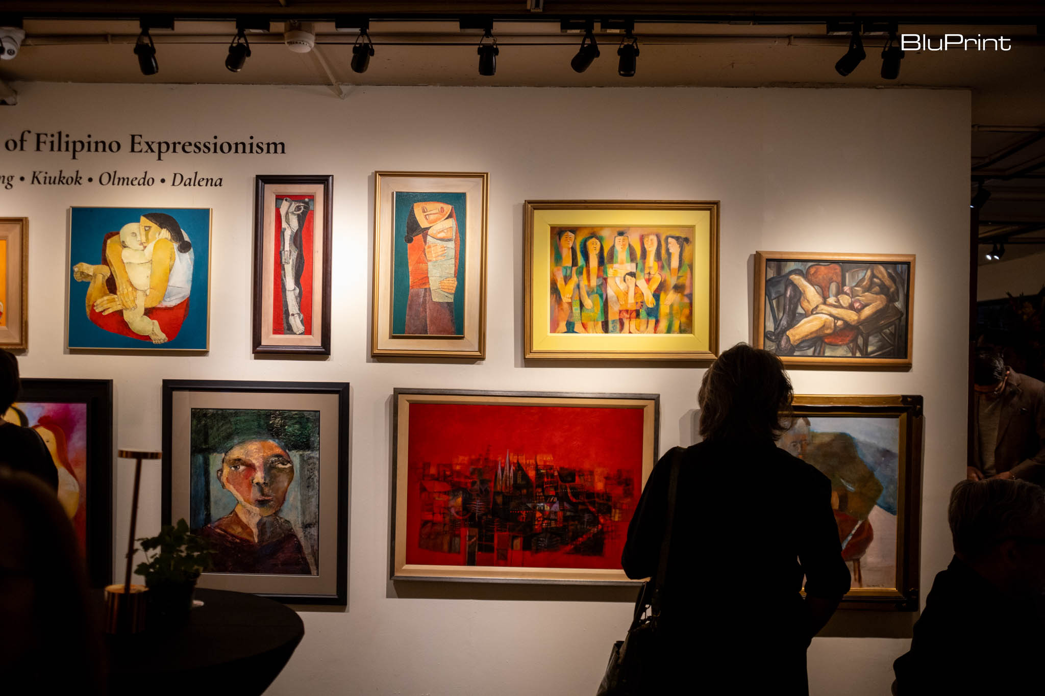 Visitors looking at the paintings of Filipino Expressionists.