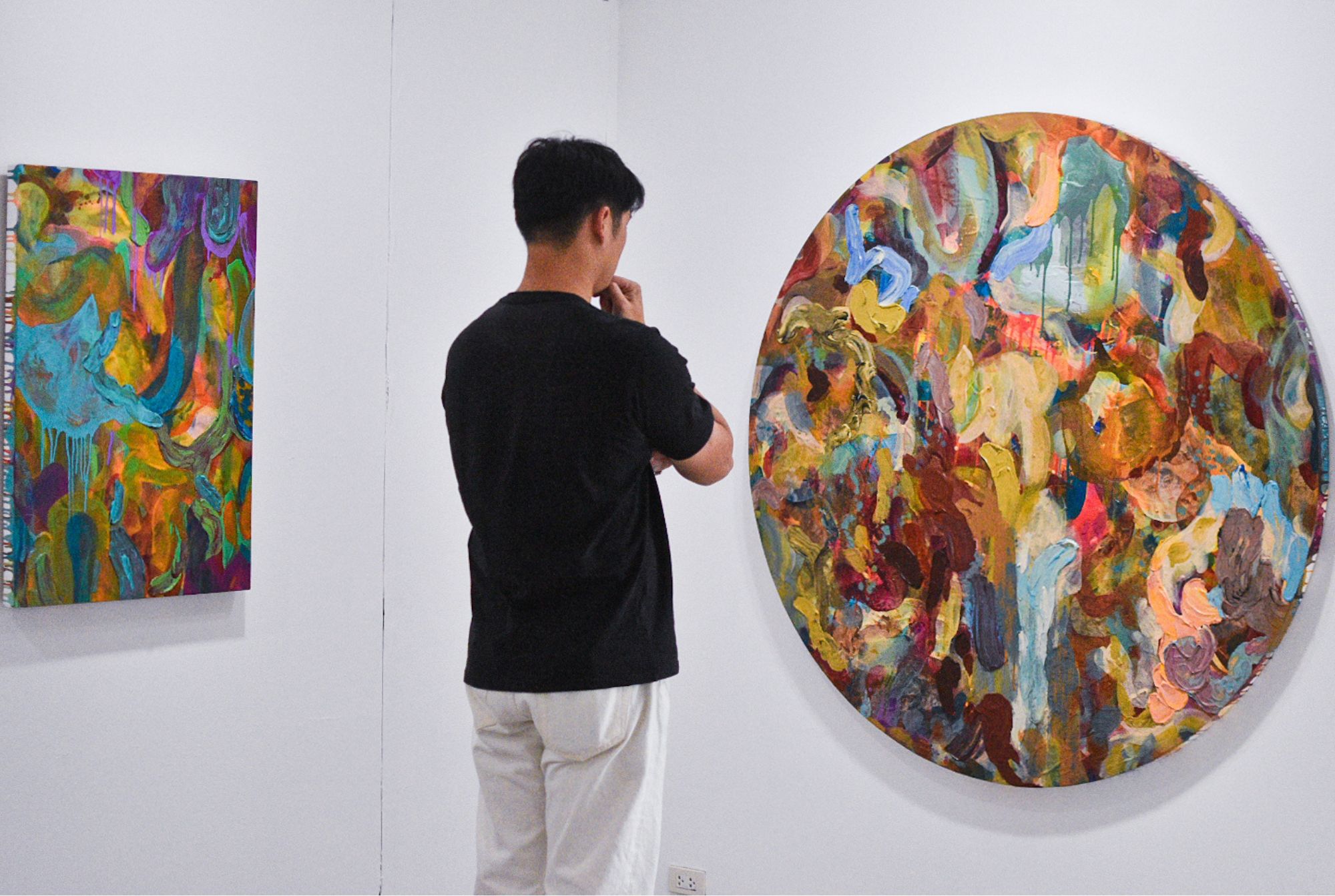 Curator Soler Santos analyzing a painting by Patrick de Veyra for "Storm in a Teacup."