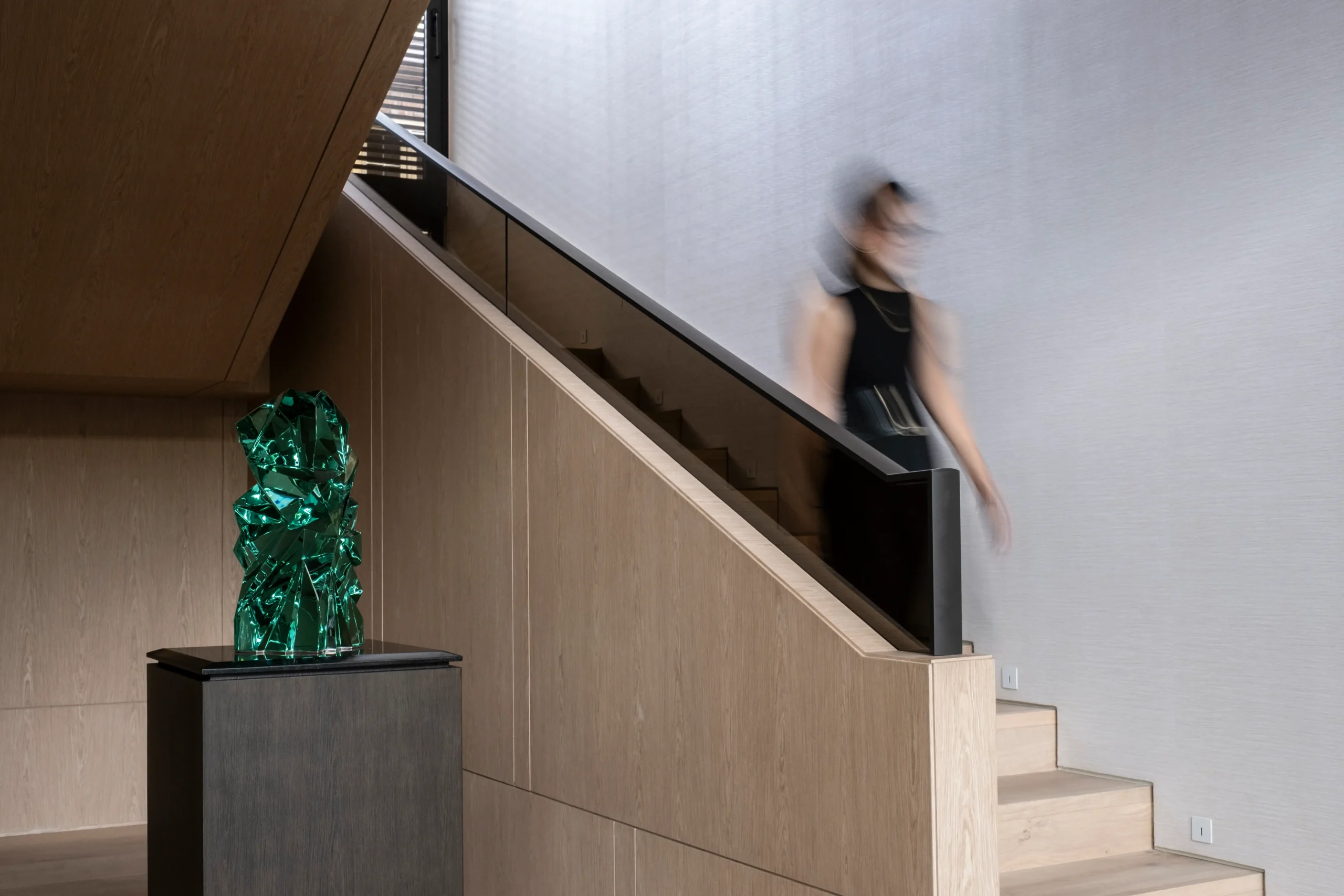 Walking down the stairs of the home. 