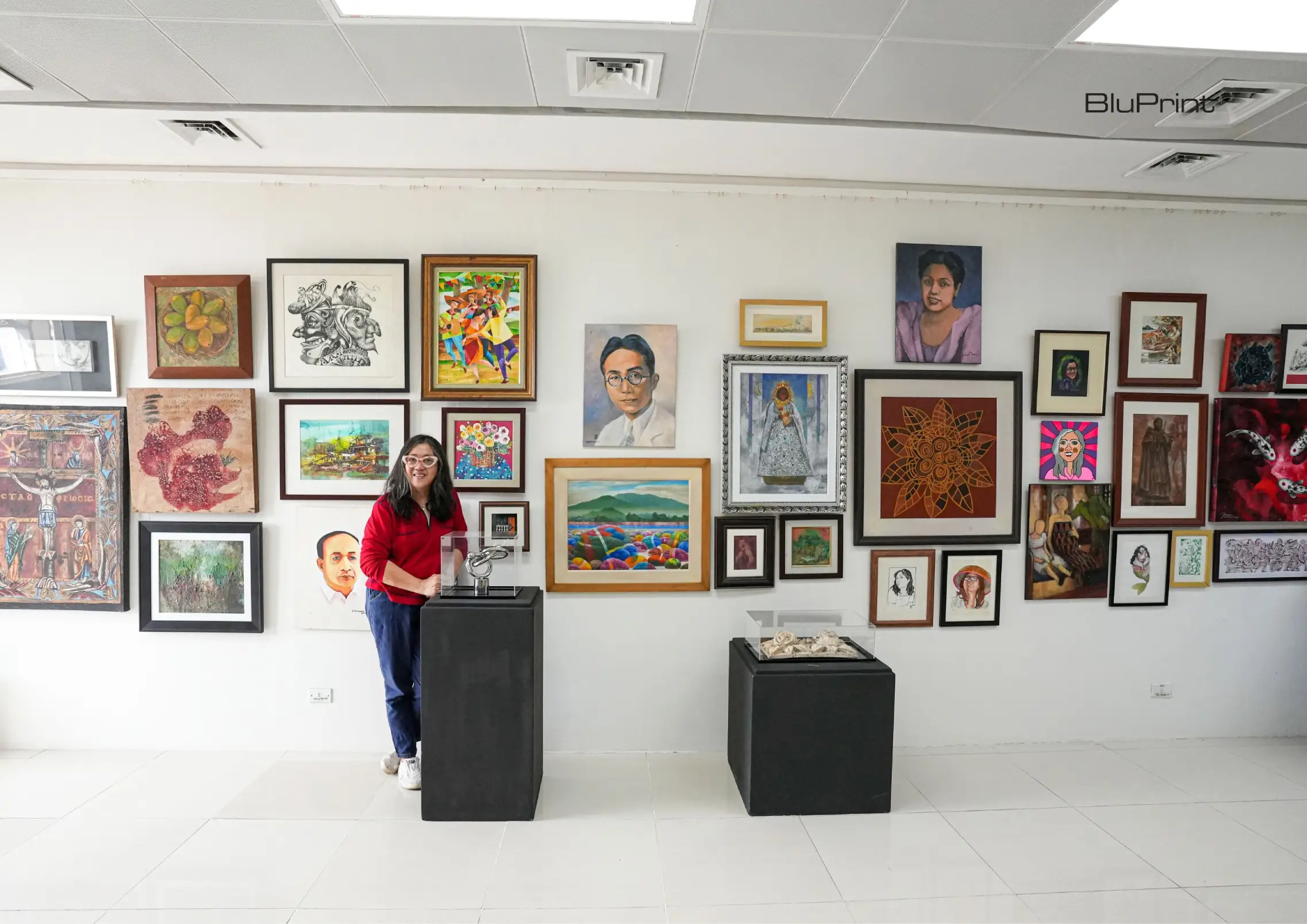 The author in front of her exhibition of paintings and other artworks that she was the curator of.
