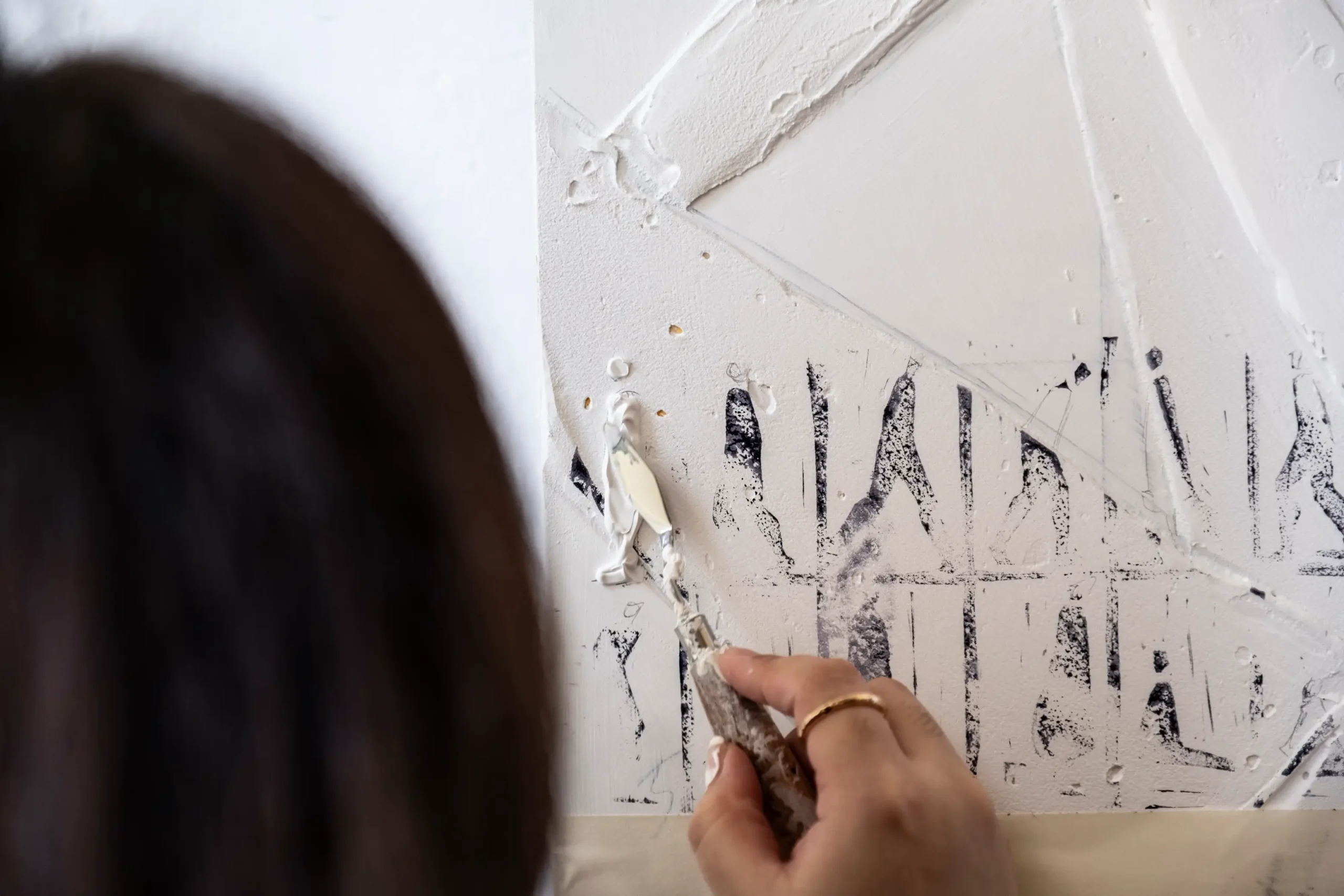 Thea Quiachon in the midst of adding one of her artworks to the canvas.