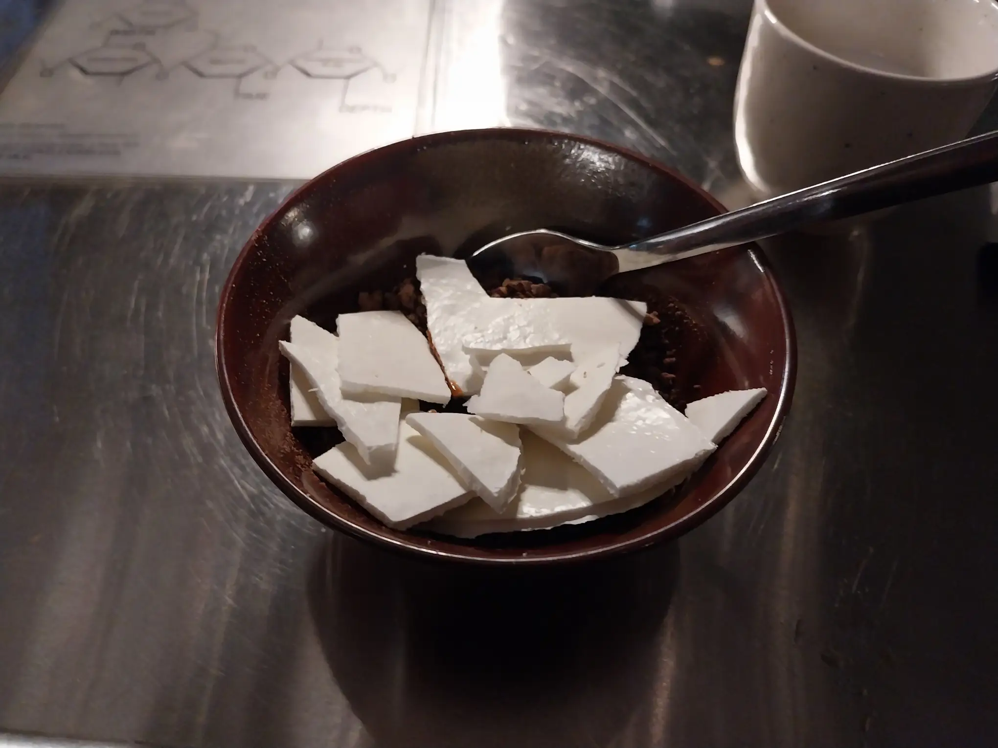 The champorado flan disk broken and ready to eat.